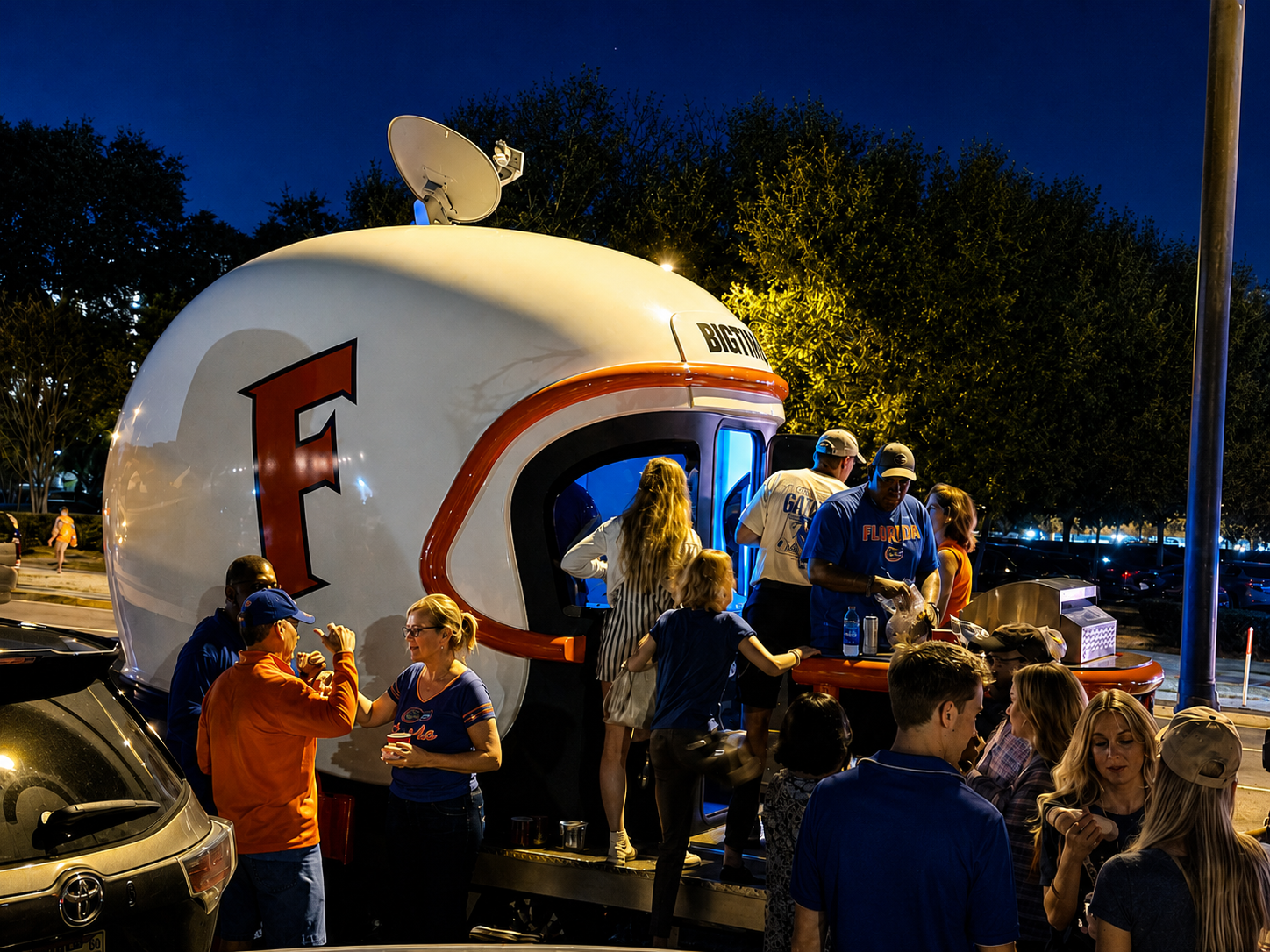 Big Time Helmets trailer surrounded by fans at a nighttime tailgate